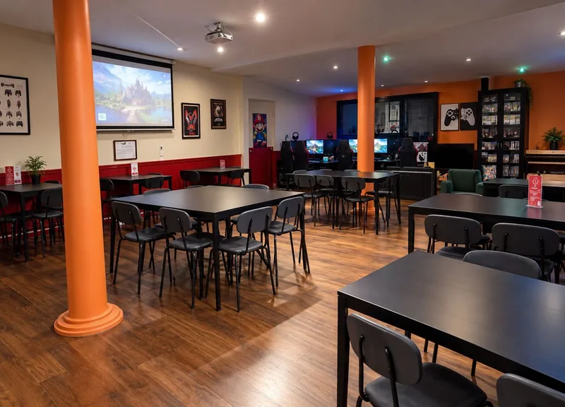 La grande salle du Repaire du Phoenix et ses tables de jeu